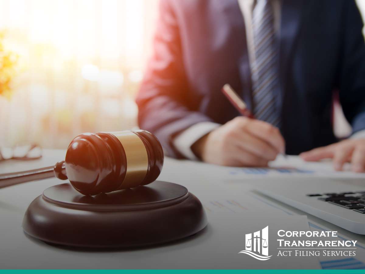 A lawyer at a desk with documents and a gavel, indicating work on Corporate Transparency Act compliance